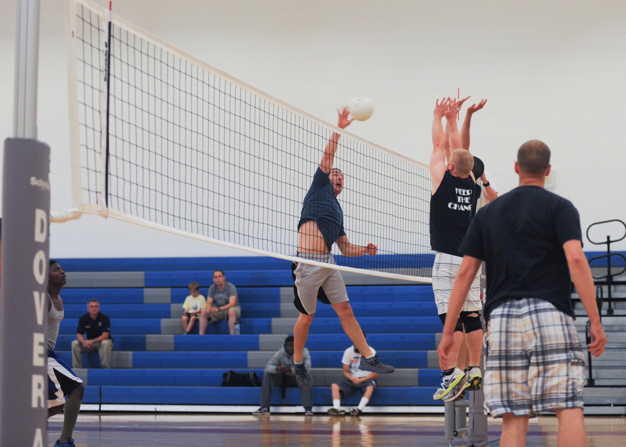 Austin Berneche, 436th Aircraft Maintenance Squadron, spikes the ball on two 436th Operations Group volleyball defenders during an intramural championship volleyball game June 6, 2014, at the fitness center on Dover Air Force Base, Del. The 436th AMXS put up a good fight but lost to the 436th Operations Group in the championship game. (U.S. Air Force photo/Senior Airman Jared Duhon) 