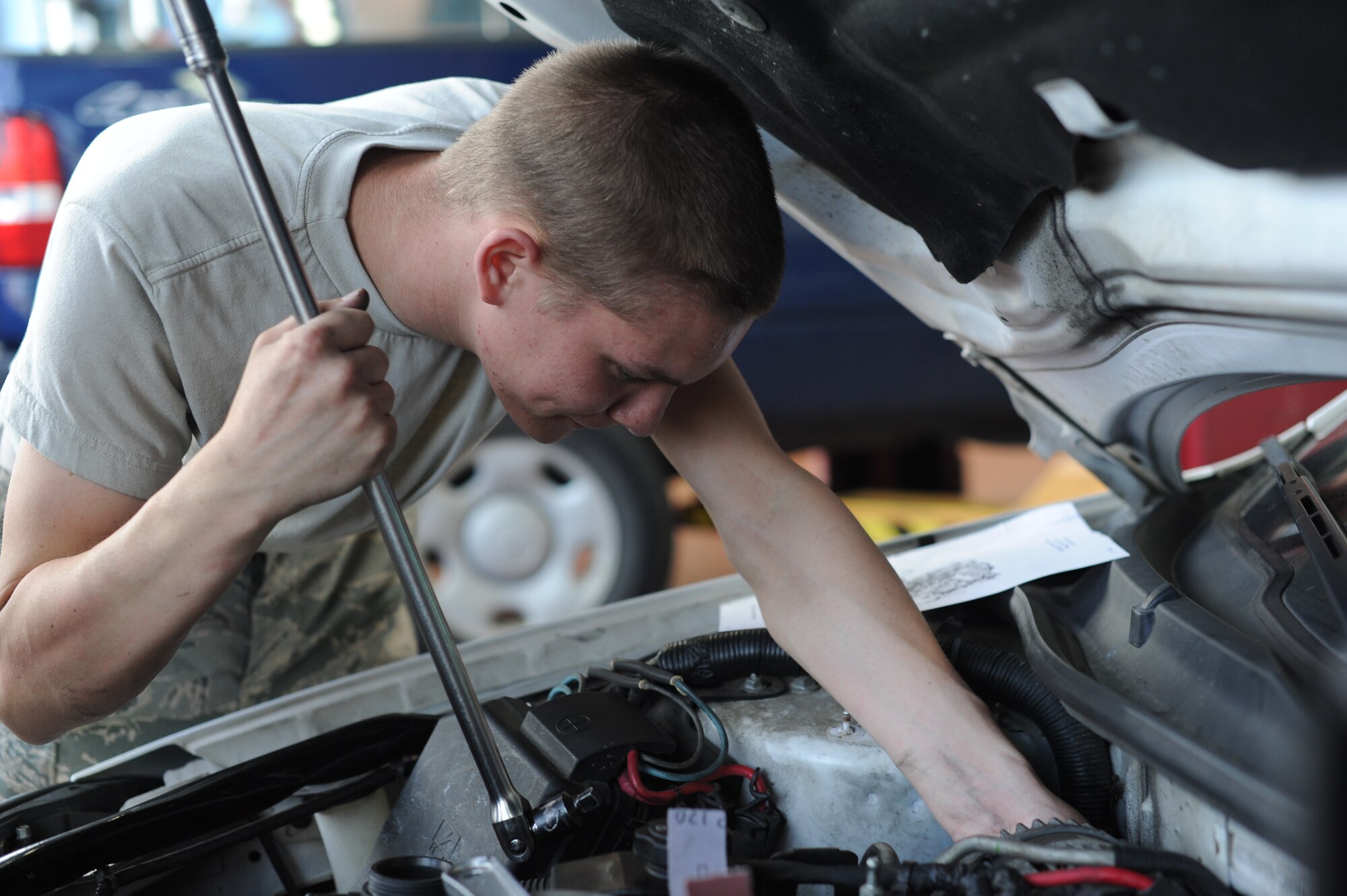U.S. Air Force Airman Christian Bell, a 52nd Logistics Readiness Squadron vehicle mechanic from Montgomery, Ala., works to replace a serpentine belt and water pump June 10, 2014, at Spangdahlem Air Base, Germany. The water pump circulates coolant to ensure the engine does not over heat. (U.S. Air Force photo by Airman 1st Class Dylan Nuckolls/Released)