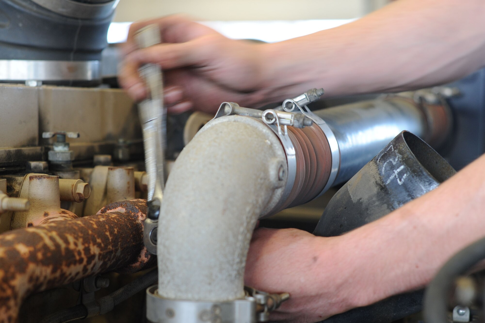 U.S. Air Force Staff Sgt. Randy Johnson, a 52nd Logistics Readiness Squadron special purpose vehicle mechanic from Newark, Ohio, works to pull the motor from an aircraft-towing vehicle June 10, 2014, at Spangdahlem Air Base, Germany. Johnson pulled the motor to replace the transmission. (U.S. Air Force photo by Airman 1st Class Dylan Nuckolls/Released)