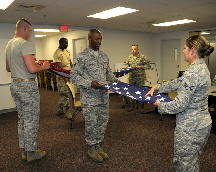 Honor guard trainees practice folding the flag on June 10, 2014 at the Niagara Falls Air Reserve Station, N.Y. Air Force Reserve and Air National Guard members from the 914th and 107th Airlift Wings including units from all over N.Y. and N.J.  attended this unique eight day training conducted by U.S. Air Force Honor Guard instructors from Joint Base Anacostia-Bolling, Washington, D.C. (U.S. Air Force photo by Peter Borys)