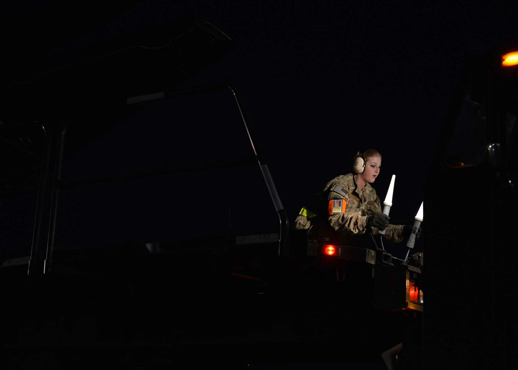 U.S. Air Force Airman 1st Class Kayla Murray, 455th Expeditionary Aerial Port Squadron aerial porter directs cargo to a C-5 Galaxy aircraft at Bagram Airfield, Afghanistan May 26, 2014.  The squadron services an average of 1,300 aircraft, 12, 000 tons of cargo and 9,000 passengers per month.  Murray is deployed from Yokota Air Base, Japan and a native of De Soto, Miss. (U.S. Air Force photo by Staff Sgt. Evelyn Chavez/Released) (Photo blurred for operational security)