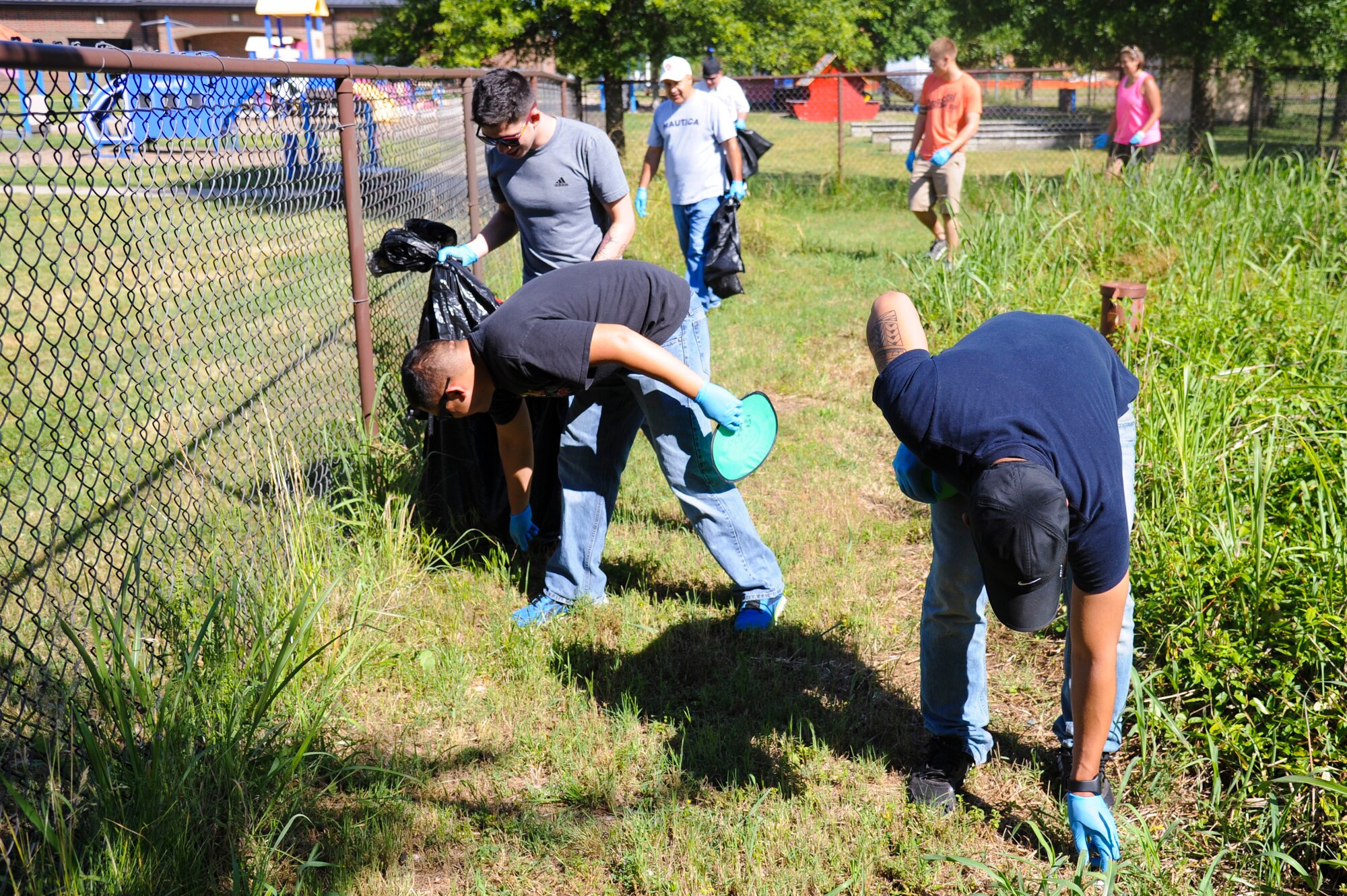Joint Base Langley-Eustis community members clean around Langley Air Force Base, Va., during Clean the Bay Day, June 7, 2014. Their efforts affect the Chesapeake Bay, which is one of America’s largest seafood suppliers according to the National Park Service. (U.S. Air Force photo by Senior Airman Austin Harvill/Released) 