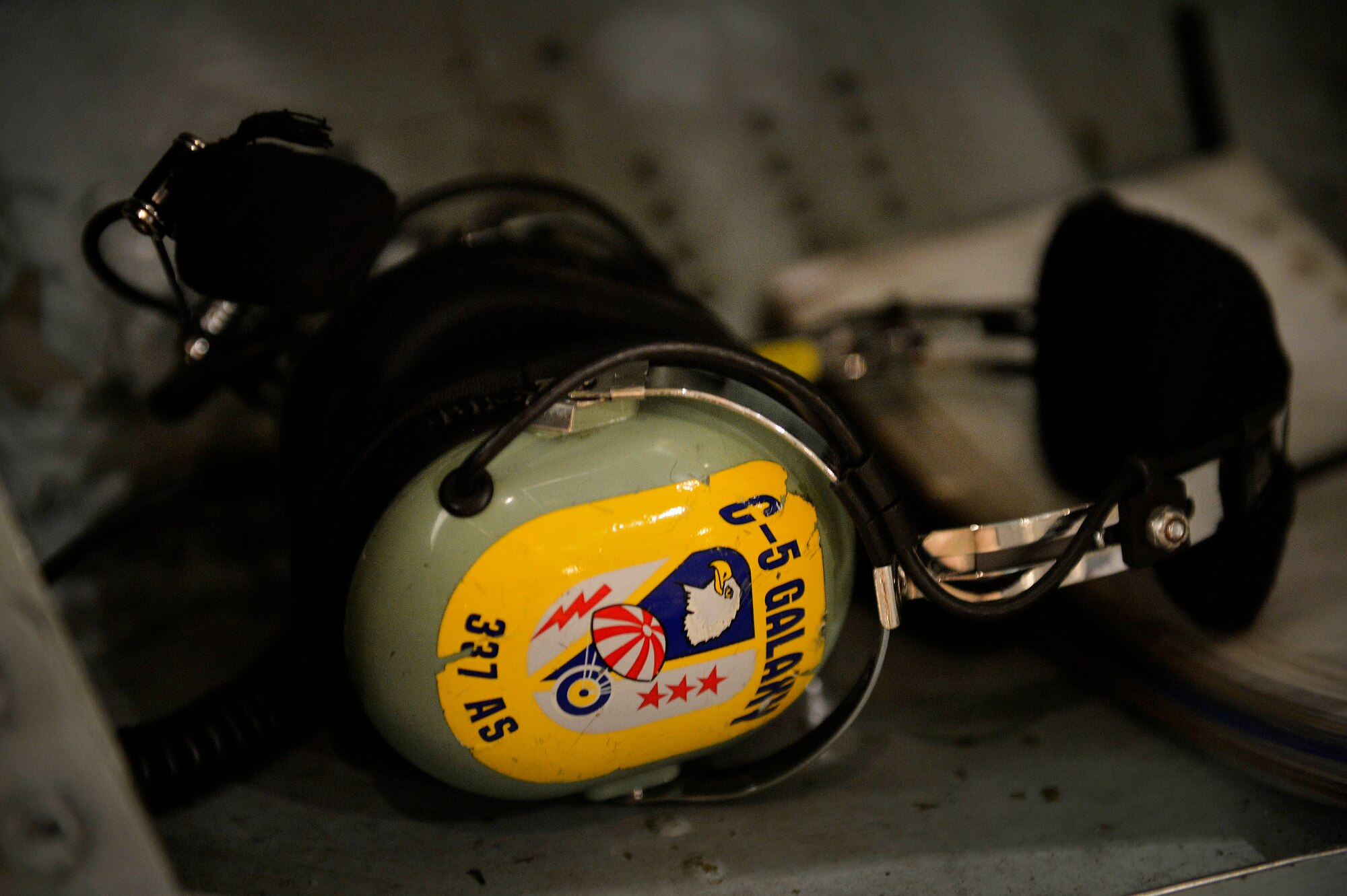 A U.S. Air Force Airman from the 337th Airlift Squadron sets his headset to the side at Bagram Airfield, Afghanistan May 26, 2014.  Airmen from the 455th Expeditionary Aerial Port Squadron loaded and unloaded cargo from a C-5 Galaxy assigned to the 439th Airlift Wing in Westover Air Reserve Base, Mass. Aerial porters here sustain cargo and passenger movement in the busiest aerial port in the Department of Defense. (U.S. Air Force photo by Staff Sgt. Evelyn Chavez/Released)  