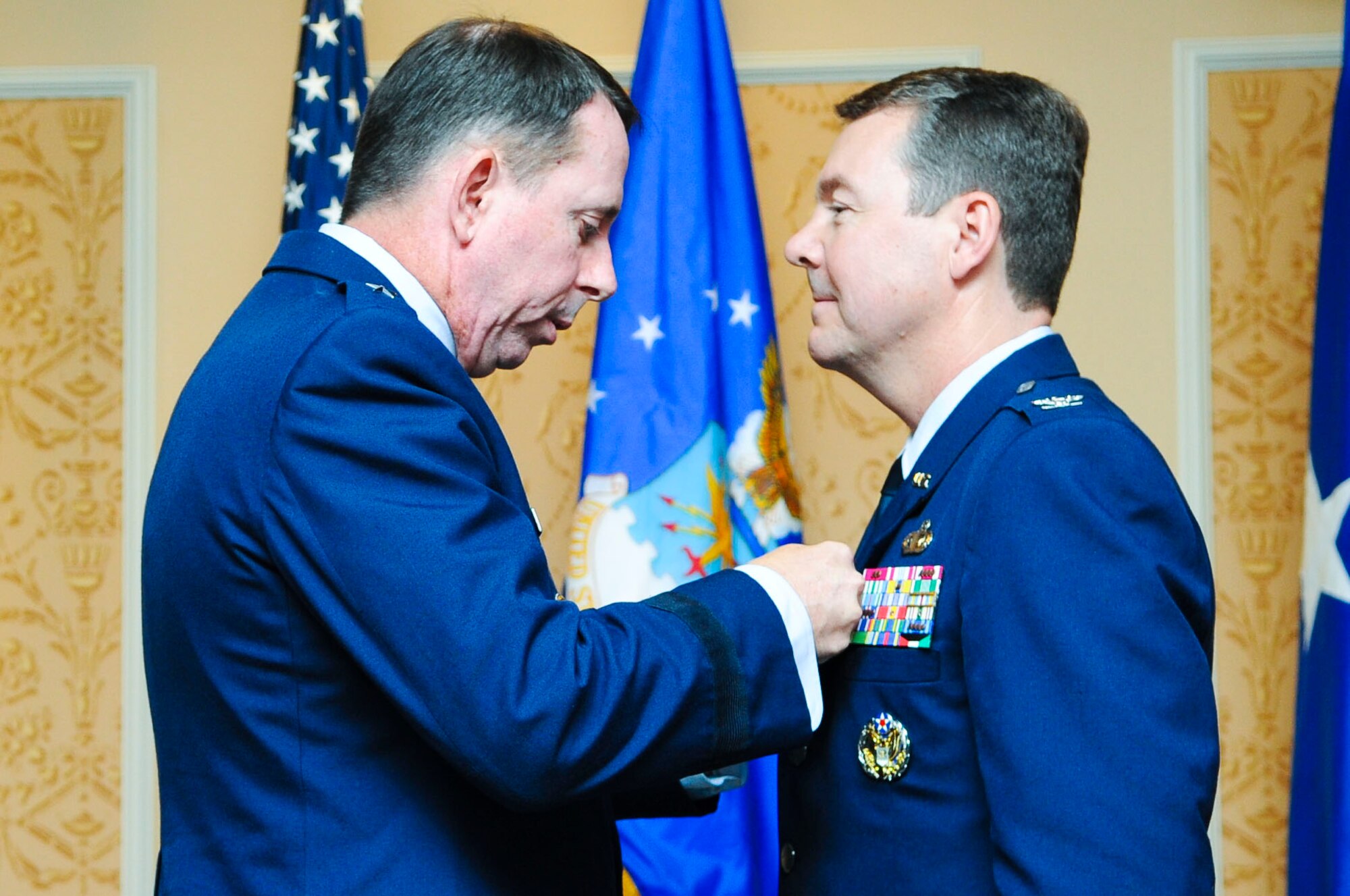 United States Air Force Maj. Gen. John Shanahan, Air Force Intelligence, Surveillance and Reconnaissance Agency commanding general, presents the Legion of Merit award to Col. Jeffrey Kruse, former 480th ISR Wing commander, during the 480th ISR Wing change of command ceremony at Langley Air Force Base, Va., June 6, 2014. Kruse earned the award through his efforts as the wing’s commander. (U.S. Air Force photo by Senior Airman Austin Harvill/Released) 