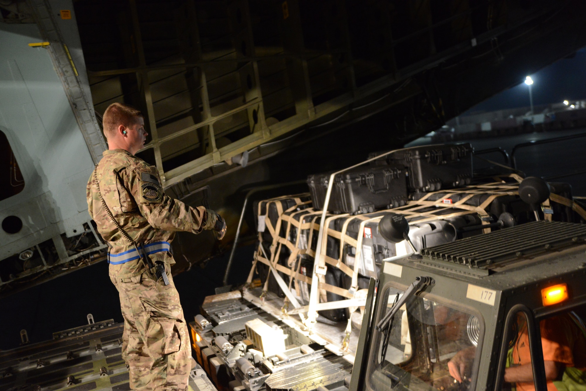 U.S. Air Force Staff Sgt. Gregory Wurzbach, 455th Expeditionary Aerial Port Squadron ramp-load team chief directs cargo to a C-5 Galaxy aircraft at Bagram Airfield, Afghanistan May 26, 2014.  The squadron services an average of 1,300 aircraft, 12, 000 tons of cargo and 9,000 passengers per month.  Wurzbach is deployed from Joint Base Pearl Harbor-Hickam, Hawaii and a native of Canton, Ohio. (U.S. Air Force photo by Master Sgt. Cohen Young/Released)