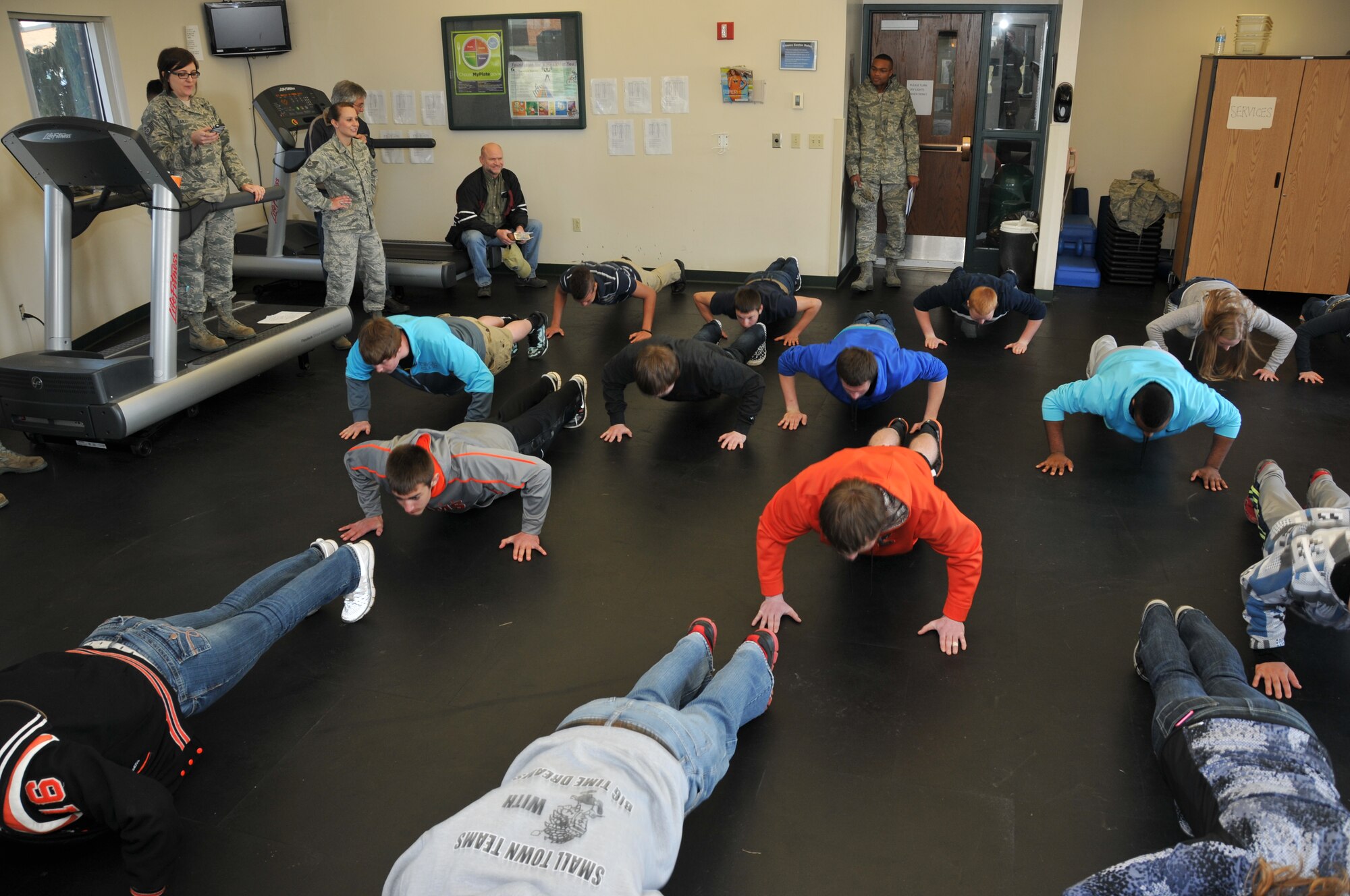 Members of the 179th Airlift Wing organize an event to help develop student athletes from the Northern 10 Athletic Conference, April 8, 2014, Galion, OH. The student athletes were seperated into teams unrelated to their schools and rotated through 6 stations designed to develop leadership skills and familiarity of Air Force customs.The students are being shown proper push up form by the student flight trainers. (U.S. Air National Guard Photo by TSgt Joseph Harwood \Released)