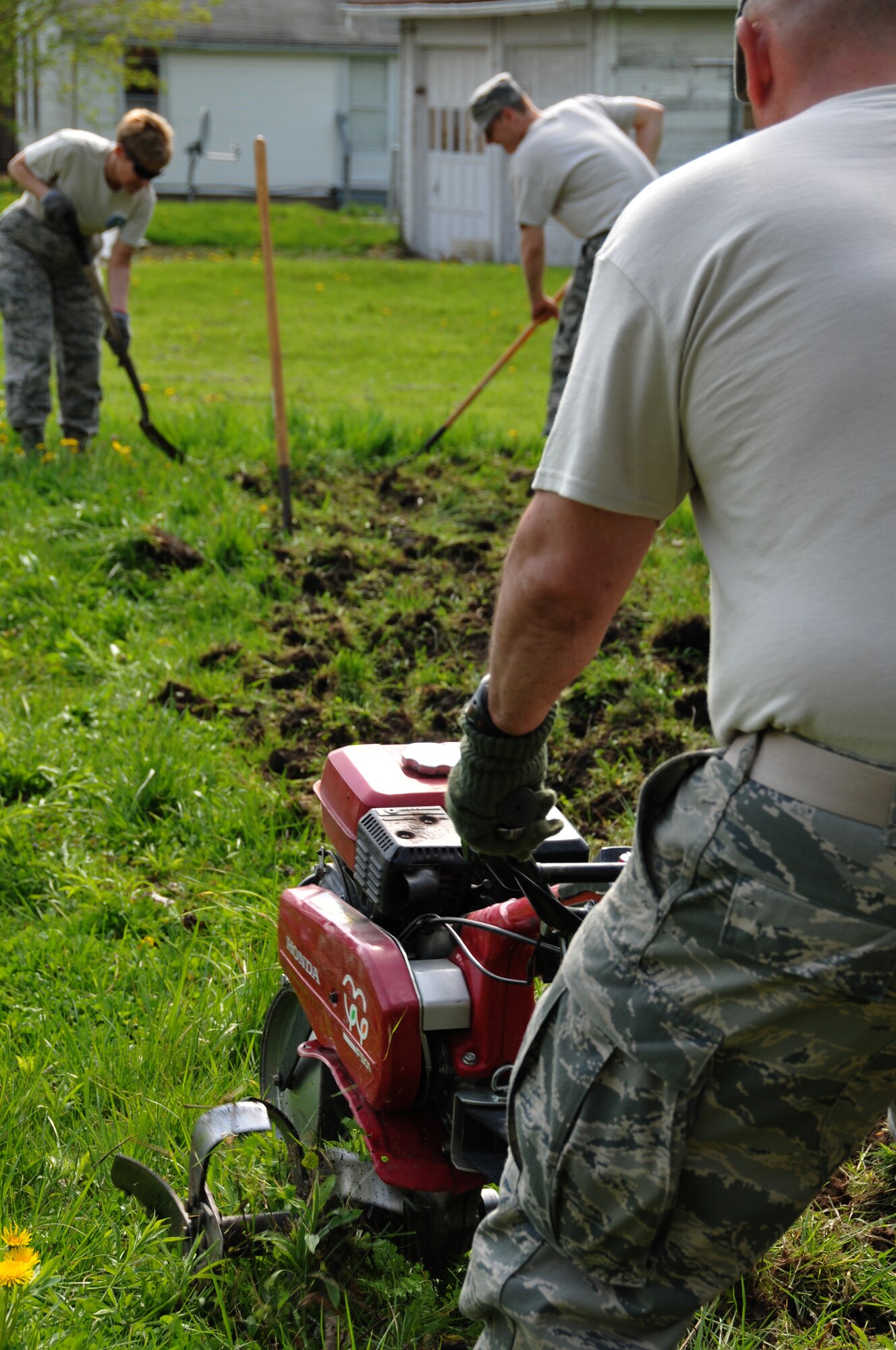 Members of the 179th Airlift Wing and 200th RED HORSE Detachment 1, team up to tackle Earth Day projects around Mansfield, OH, May 8,2014. The 179th has participated in Earth Day events for the past 15 years, with the 200th joining them for the last four years. The members are working with local schools and the North End Community Improvement Collaborative to help clean up Mansfield this spring. (U.S. Air National Guard Photo by TSgt Joseph Harwood \Released)