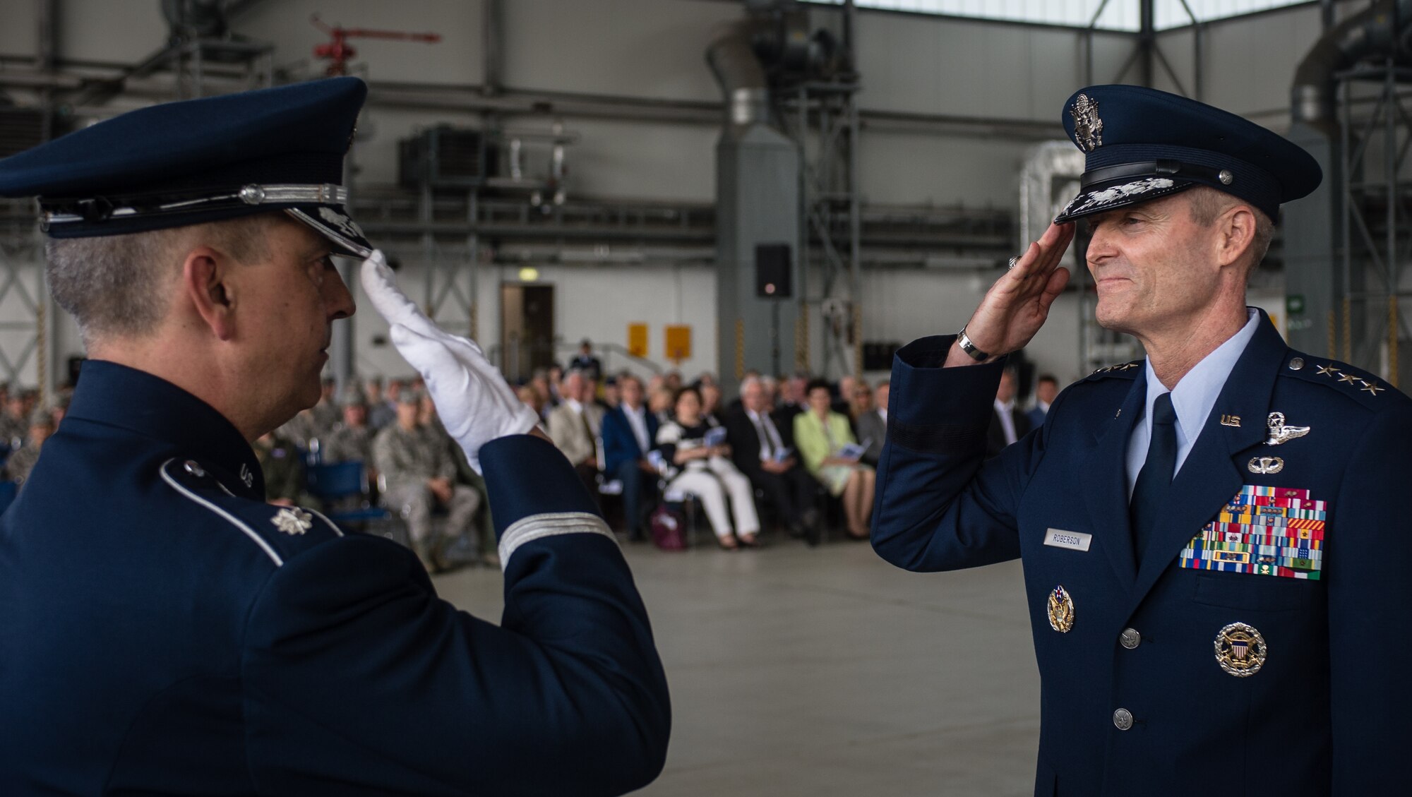 Lt. Gen. Darryl Roberson, 3rd Air Force commander, returns a salute to Lt. Col. Mike mench, U.S. Air Forces in Europe and Air Forces Africa band commander, during the 3rd Air Force assumption of command ceremony June 11, 2014, Ramstein Air Base, Germany. Roberson comes to 3rd Air Force from his previous assignment as the vice director of operations on the joint staff in Washington, D.C.  The command provides full-spectrum Air Force war-fighting capabilities throughout an area of responsibility that spans three continents and encompasses 104 countries. (U.S. Air Force photo/ Airman 1st Class Jordan Castelan)