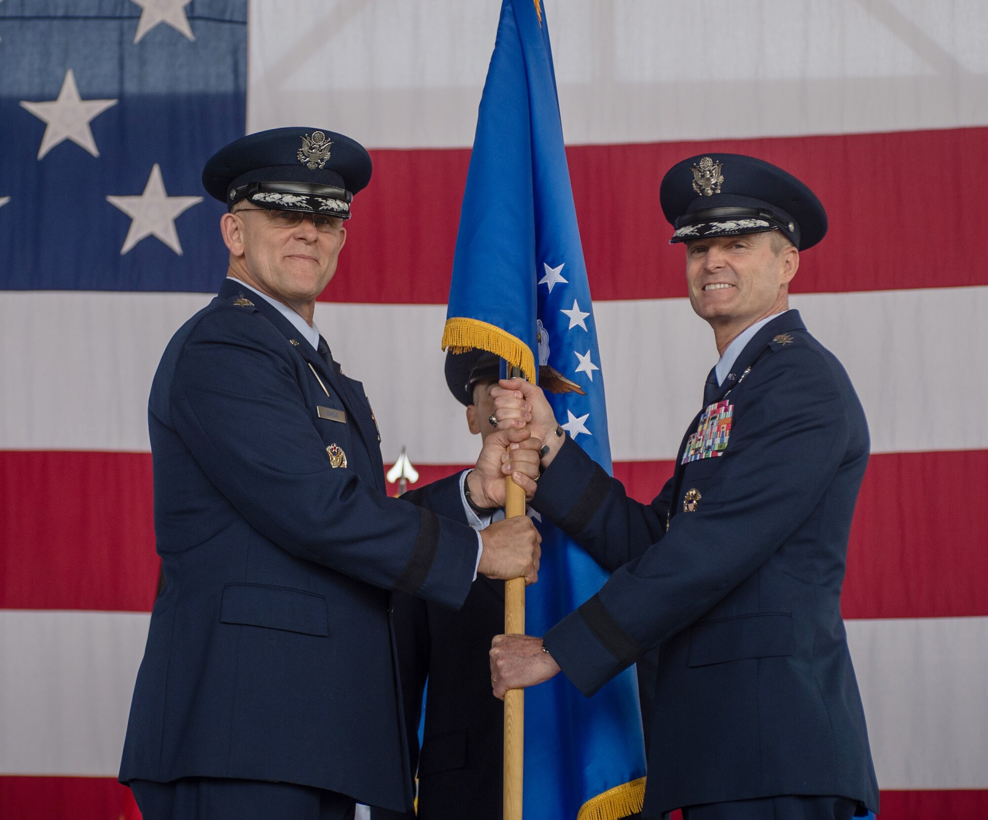 Gen. Frank Gorenc, U.S. Air Forces in Europe and Air Force Africa commander, passes the 3rd Air Force guidon to Lt. Gen. Darryl Roberson, 3rd Air Force commander during an assumption of command ceremony June 11, 2014, Ramstein Air Base, Germany. Roberson comes to 3rd Air Force from his previous assignment as the vice director of operations on the joint staff in Washington, D.C. The command provides full-spectrum Air Force war-fighting capabilities throughout an area of responsibility that spans three continents and encompasses 104 countries.