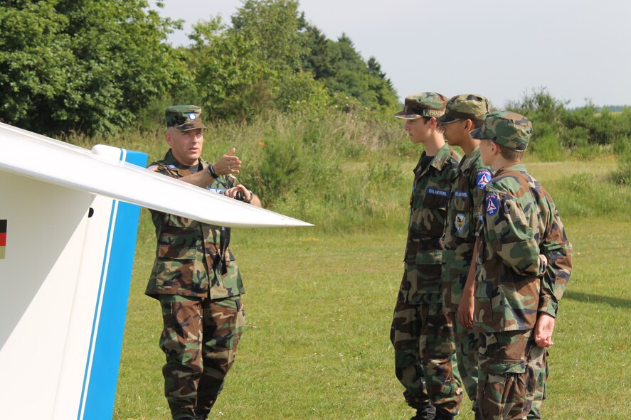 Civil Air Patrol Lt. Col. Chad Morris, Spangdahlem Cadet Squadron commander, instructs Cadets Sean Cannon, Andrew Cannon and Teagan Thomas before flying in an ASK-21 Glider during a Flight Orientation Program June 8, 2014. The glider was launched into the air in about three seconds using a winch system. (Courtesy photo/released)