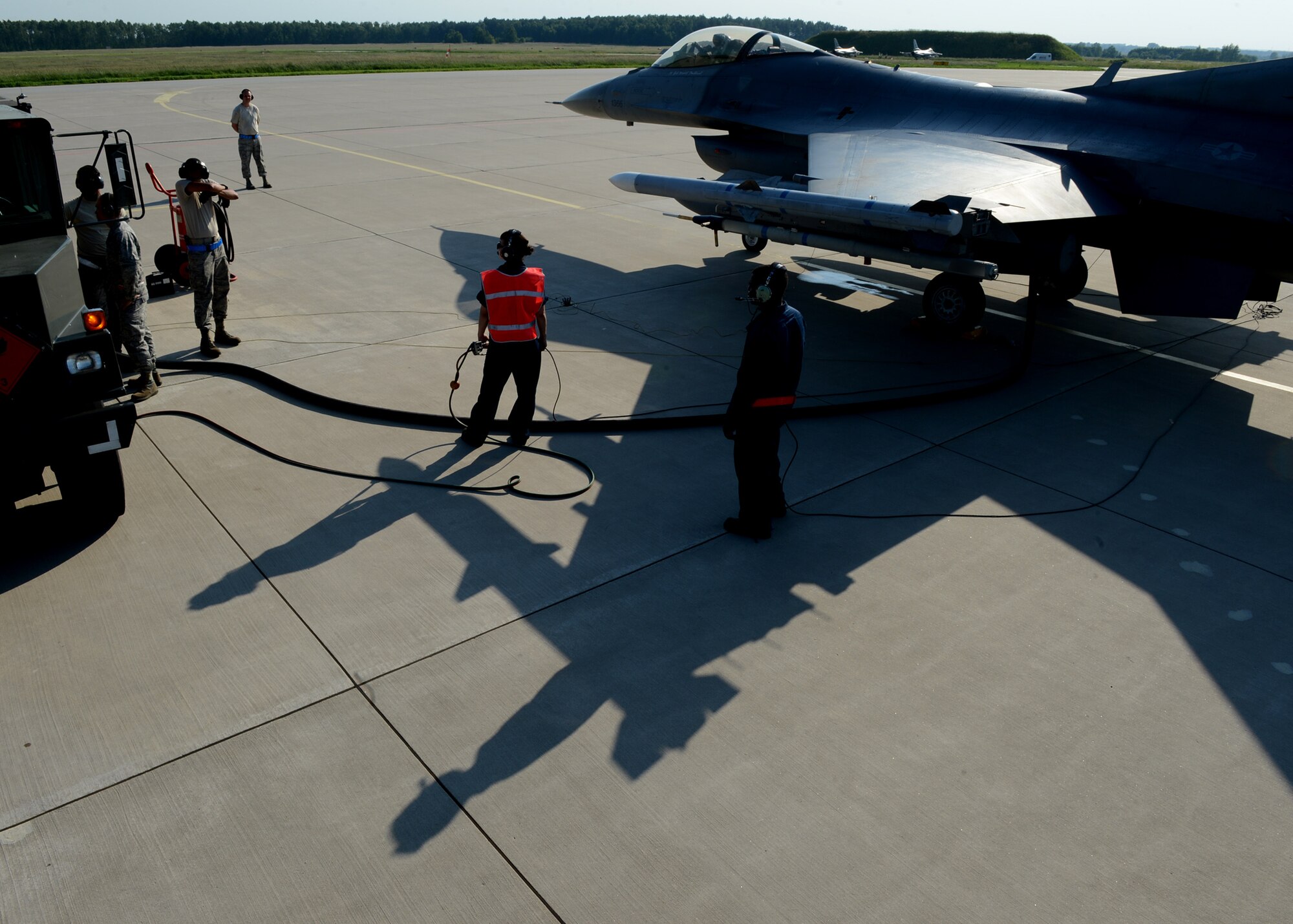 U.S. Air Force Airmen from Spangdahlem Air Base, Germany, refuel a returning U.S. Air Force F-16 Fighting Falcon fighter aircraft at Lask Air Base, Poland, June 9, 2014. The Polish Air Force refuels aircraft during the daily flying operations, while the U.S. Air Force executes hot pit refueling, which shortens the flying window and increases capability to fix aircraft in a timely manner. This is the first time it has been done in Poland by U.S. Forces. Their efforts support Exercise EAGLE TALON, BALTOPS 14 and U.S. Aviation Detachment Rotation 14-3. (U.S. Air Force photo by Airman 1st Class Kyle Gese/Released)