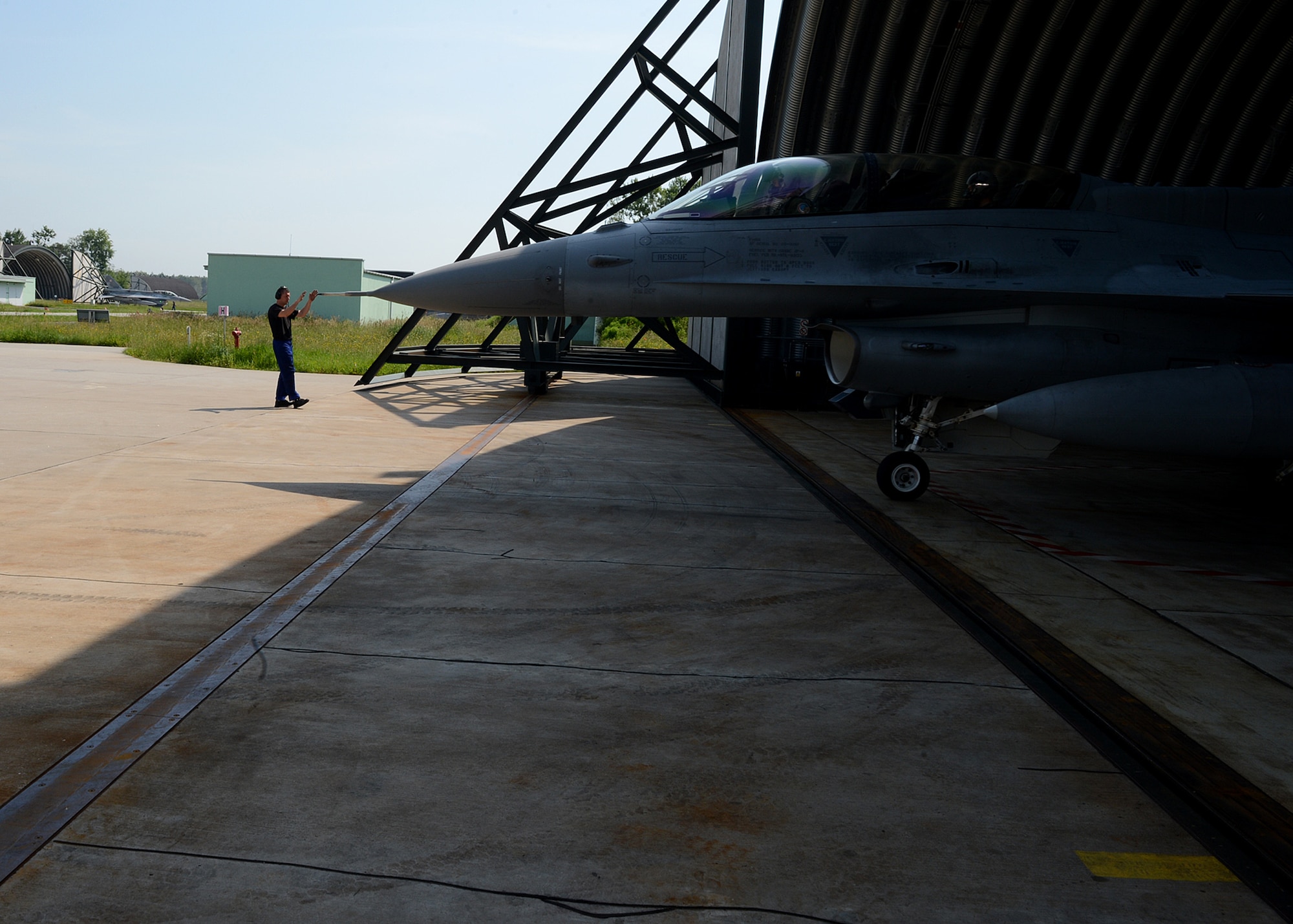 Polish air force Warrant Officer Cichecki Martin, crew chief, taxies a Polish air force F-16 Fighting Falcon fighter aircraft during Exercise EAGLE TALON at Lask Air Base, Poland, June 10, 2014. Exercise EAGLE TALON enhances pilots’ abilities to operate with NATO allies, accomplish large force formations and execute air-to-air and air-to-surface missions. (U.S. Air Force photo by Airman 1st Class Kyle Gese/Released)