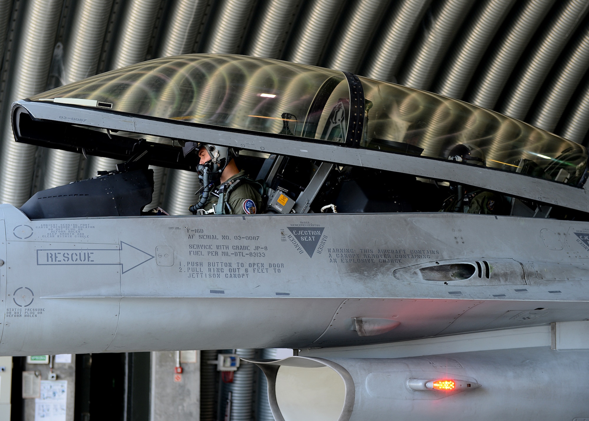 Polish air force 1st Lt. Tomasz Grzybowski, F-16 Fighting Falcon fighter aircraft pilot, and Polish air force 2nd Lt. Komrad Zwolinski, TS-11 and PZL-130 pilot, closes the canopy of the aircraft for departure at Lask Air Base, Poland, June 10, 2014. Grzybowski and Zwolinski participated in Exercise EAGLE TALON, a Polish-led combined exercise, with NATO partners to increase interoperability and familiarize themselves with foreign procedures. (U.S. Air Force photo by Airman 1st Class Kyle Gese/Released)