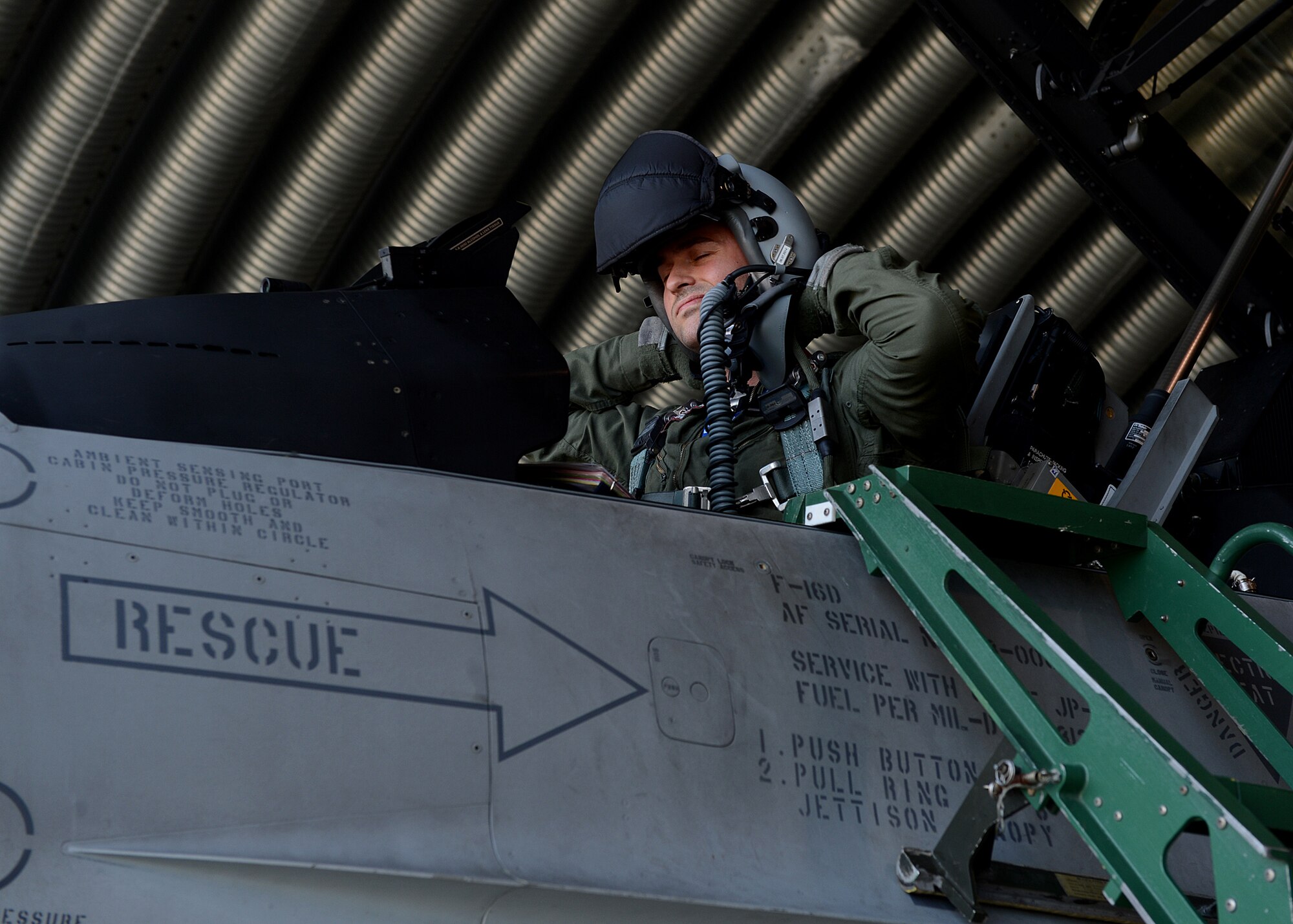 Polish air force 1st Lt. Tomasz Grzybowski, F-16 Fighting Falcon fighter aircraft pilot, puts on his helmet in preparation to fly with U.S. and NATO allies at Lask Air Base, Poland, June 10, 2014 during Exercise EAGLE TALON, a Polish-led combined exercise. This is the first time the U.S. has participated in this exercise, which trains pilots to attack and defend targets with NATO allies. Training together in partnership enhances understanding of each other’s tactics and procedures for future combined operations. (U.S. Air Force photo by Airman 1st Class Kyle Gese/Released)
