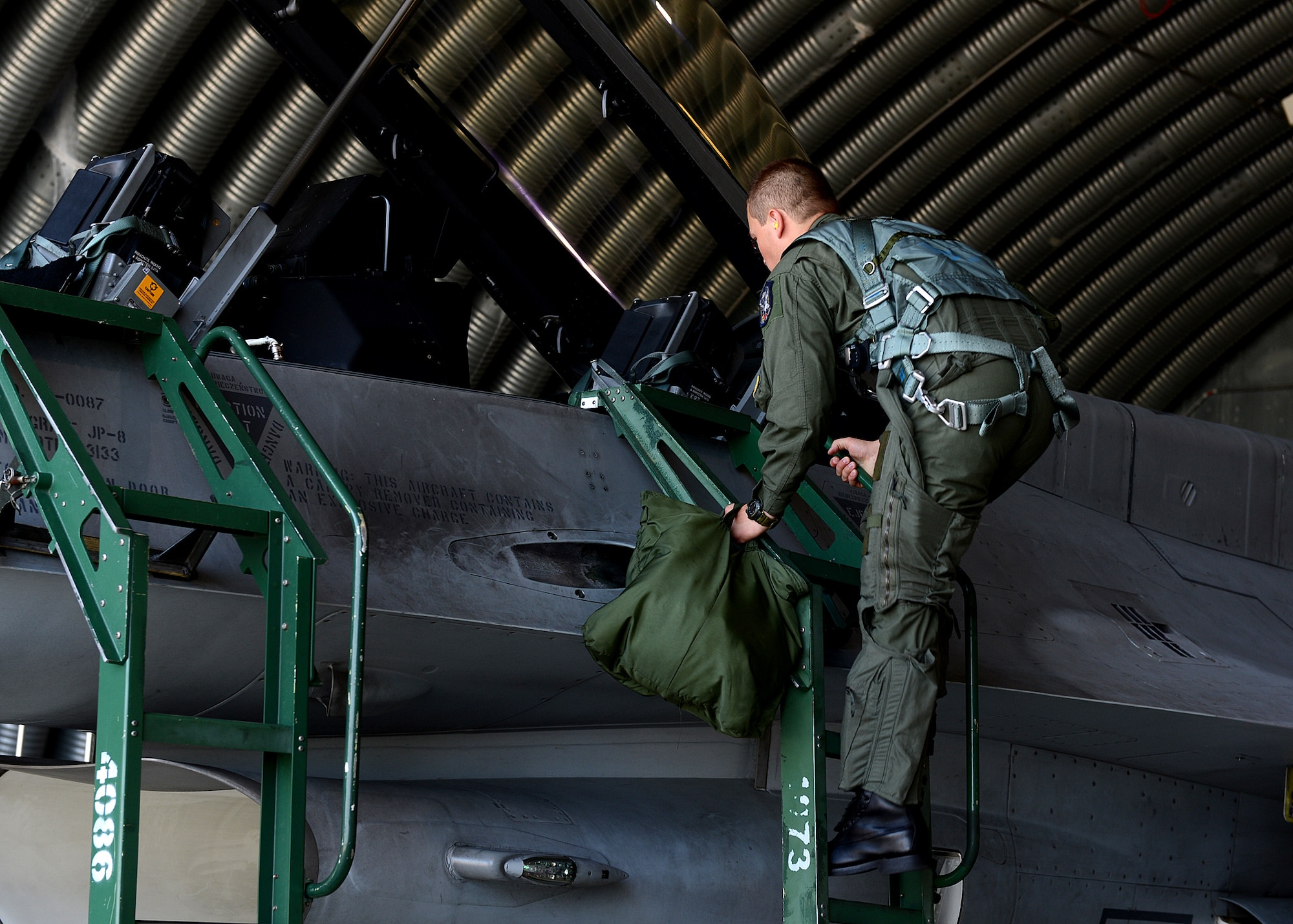 Polish air force 2nd Lt. Komrad Zwolinski, TS-11 and PZL-130 training aircraft pilot, boards an F-16 Fighting Falcon fighter aircraft at Lask Air Base, Poland, June 10, 2014, for a familiarization flight during Exercise EAGLE TALON. Zwolinski will be an F-16 pilot, and is waiting for a training slot in the U.S. with the U.S. Air Force. The Polish air force hosted Exercise EAGLE TALON for U.S., French and British air assets to increase interoperability and strengthen NATO ties. This is the first time the U.S. participated in this exercise. (U.S. Air Force photo by Airman 1st Class Kyle Gese/Released)