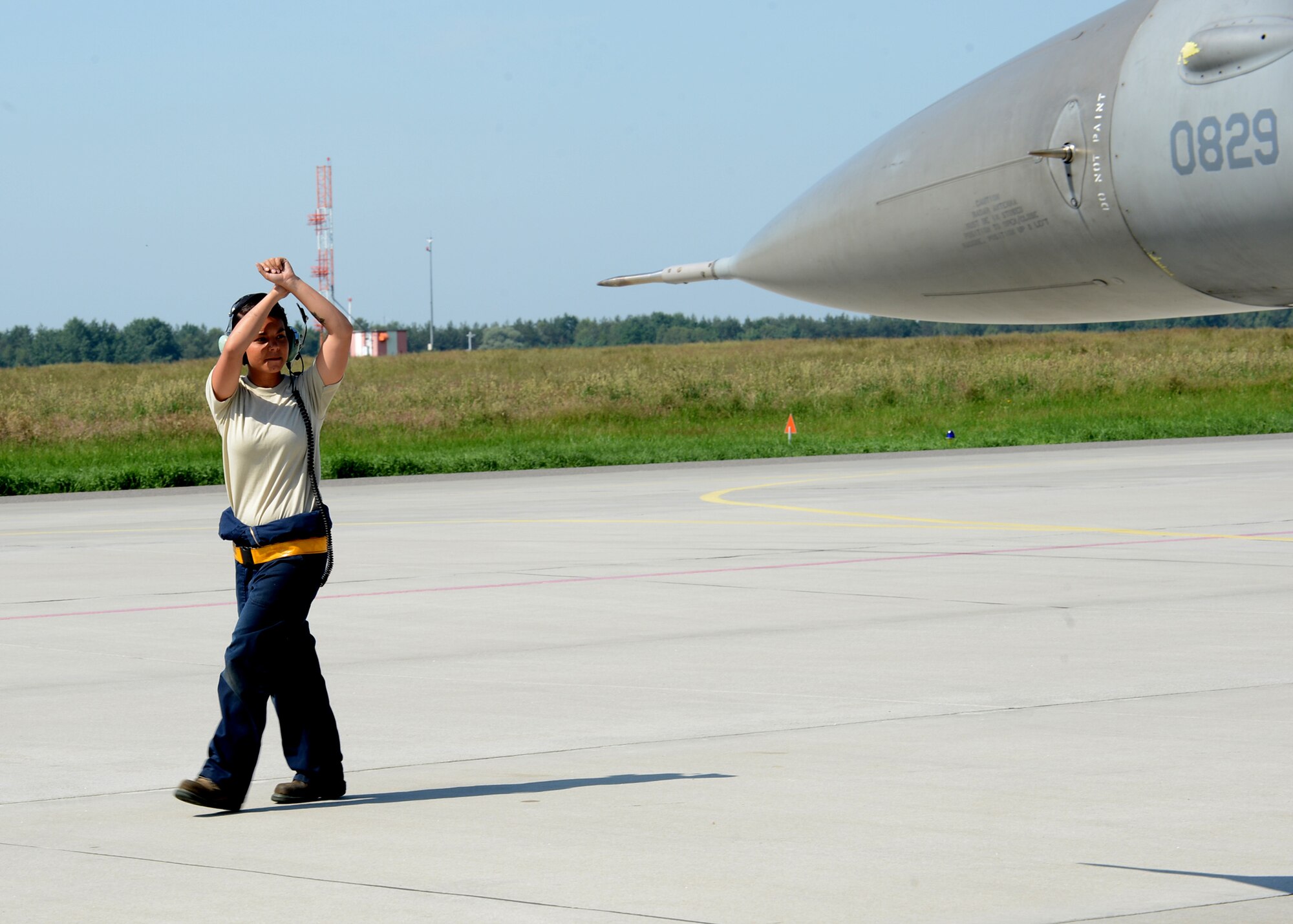 U.S. Air Force Senior Airman Kimberly Szydlowski, a 52nd Aircraft Maintenance Squadron F-16 Fighting Falcon fighter aircraft crew chief from St. Louis, directs an F-16 pilot before departure at Lask Air Base, Poland, June 9, 2014. The U.S. Aviation Detachment in Poland supported the rotation of USAF F-16s to Poland to support various combined exercises, including the Polish-led exercise EAGLE TALON. Exercises such as these build partnership capacity between NATO allies and strengthen strategic partnerships. (U.S. Air Force photo by Airman 1st Class Kyle Gese/Released)