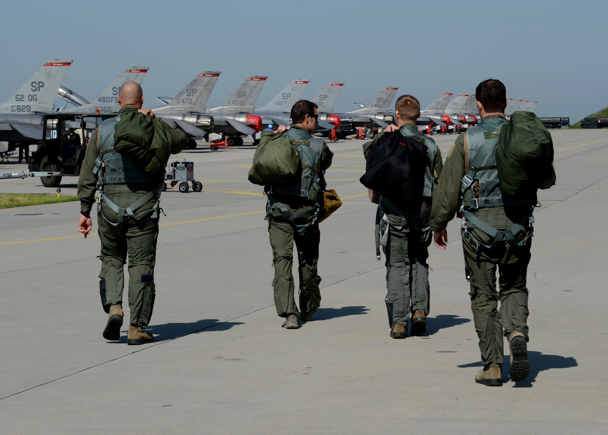 U.S. Air Force pilots walk to their aircraft to fly with NATO allies during exercise EAGLE TALON at Lask Air Base, Poland, June 9, 2014. This exercise represents the first time the U.S. has participated in the Polish-led exercise. Polish armed forces trained with U.S. pilots to increase interoperability with air-to-air and air-to-surface capabilities for future NATO operations. The exercise encompasses large-force formations that focus on mastering air defense. (U.S. Air Force photo by Airman 1st Class Kyle Gese/Released)