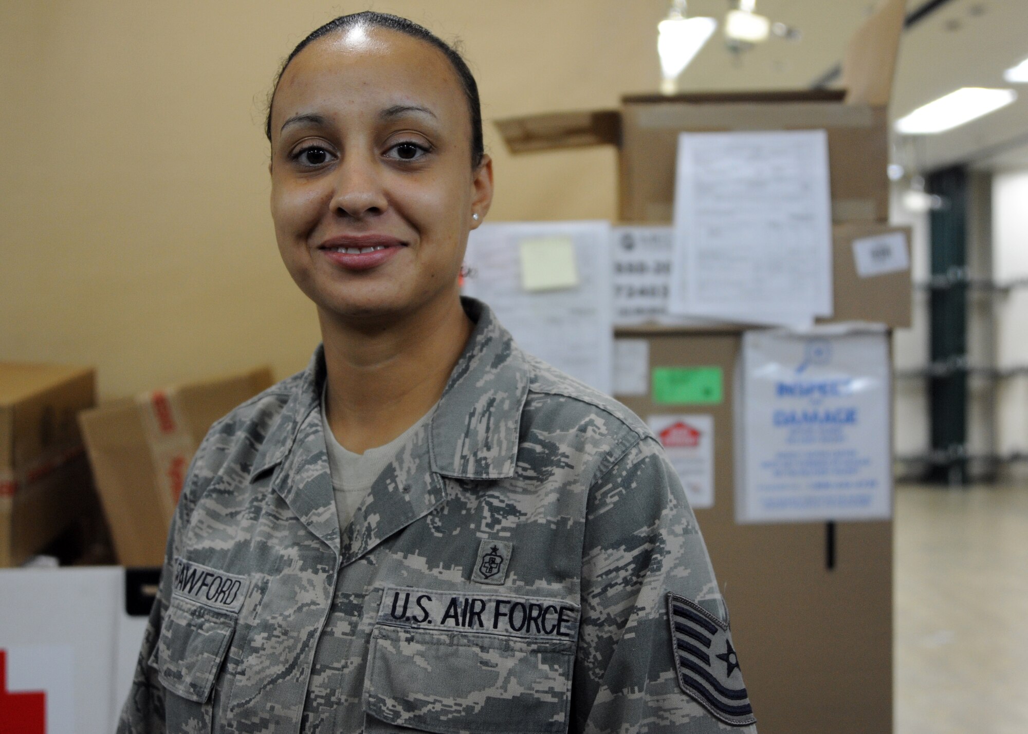 Tech. Sgt. Christine Crawford, 35th Medical Support Squadron NCO in charge of war reserve materiel and the medical equipment management office, poses in the base hospital's warehouse at Misawa Air Base, Japan, June 3, 2014. Crawford, a native of Detroit, was chosen as her squadron's Wild Weasel of the Week. (U.S. Air Force photo/Staff Sgt. Alyssa C. Wallace)
