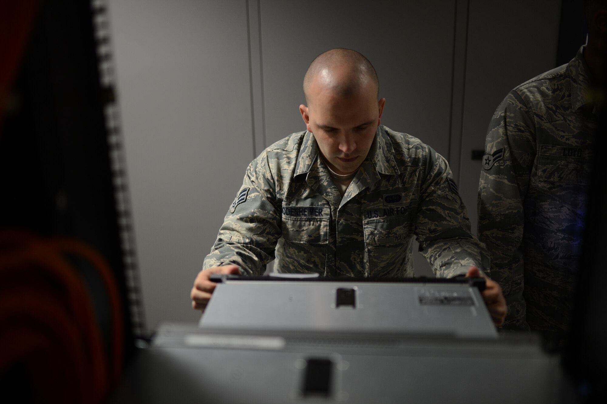 U.S. Air Force Senior Airman Edward Bodenheimer, 52nd Communications Squadron cyber system operations technician from Lumberton, N.C., studies a network server in a server room at Spangdahlem Air Base, Germany, June 10, 2014. The 53 servers and $45 million network supports the base population and geographically separated units totaling more than 4,000 client systems. (U.S. Air Force photo by Senior Airman Gustavo Castillo/Released)