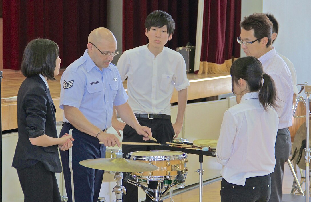 NAGAOKA CITY, Japan -- Staff Sgt Wildfredo Cruz, Band of the Pacific-Asia percussionist, demonstrates proper snare drum technique with the music students at Teikyo High School, Nagaoka City, Niigata, Japan, June 5th, 2014. The event included interactive music clinics and a bilateral performance with the school’s “Teikyo Nagaoka Wind Orchestra.” (U.S. Air Force photo by Staff Sgt. Geoffrey Fisher)