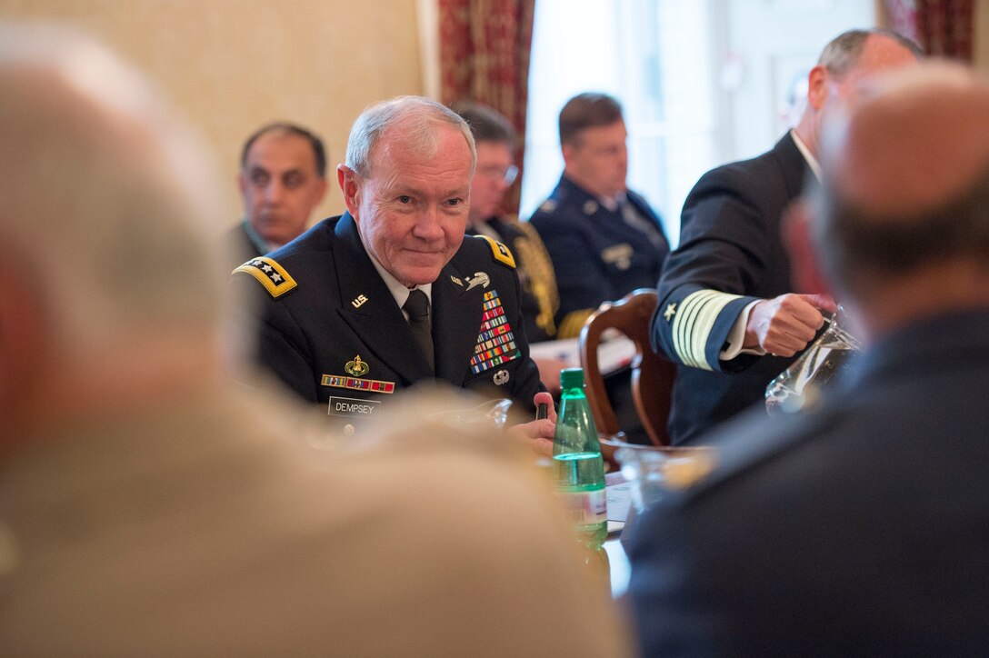 U.S. Army Gen. Martin E. Dempsey, center, chairman of the Joint Chiefs of Staff, listens as British Defense Secretary Philip Hammond talks during meetings with their British counterparts in London, June 10, 2014.
