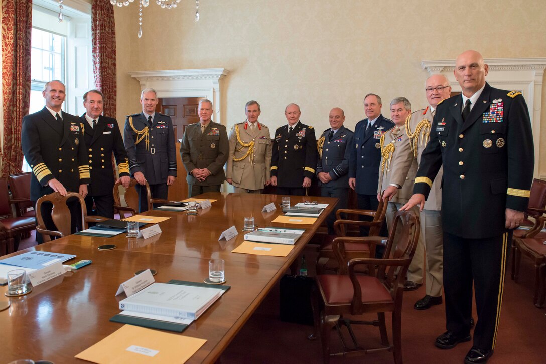 U.S. Army Gen. Martin E. Dempsey, right center, chairman of the Joint Chiefs of Staff, British Gen. Nicholas Houghton, left center, chief of Britain's defense staff, and U.S. and British military chiefs pose for a photograph in London, June 10, 2014.