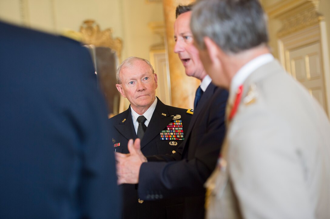U.S. Army Gen. Martin E. Dempsey, center, chairman of the Joint Chiefs of Staff, listens as British Prime Minister David Cameron talks during meetings with U.S. and British counterparts in London, June 10, 2014.