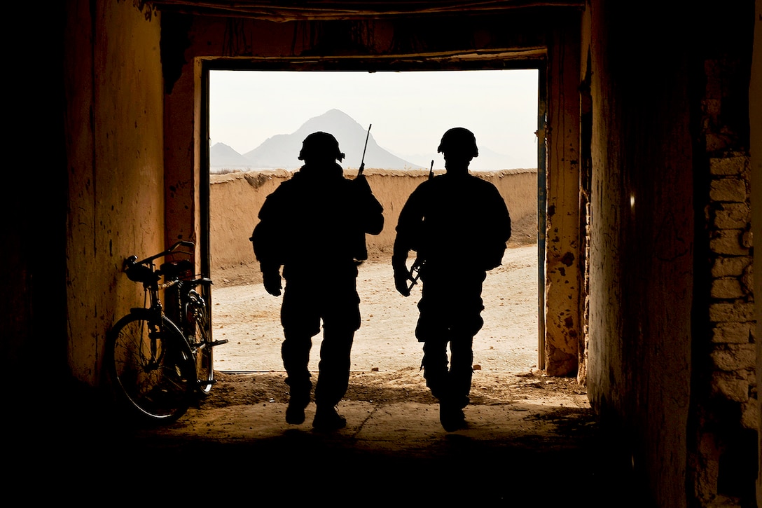 U.S. Army Staff Sgt. Mark Lynas, left, and Sgt. Mark Record secure a school and clear insurgent threats in a village in Shah Joy, Afghanistan, Nov. 22, 2011. Lynas, a squad leader, and Record, a team leader, are members of Provincial Reconstruction Team Zabul. Both sergeants are deployed from Company C, 182nd Infantry Regiment, Massachusetts National Guard.  
