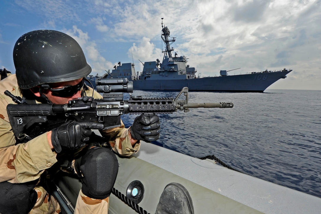 U.S. Navy Petty Officer 3rd Class Tyler Long sets a bubble perimeter in a rigid hull inflatable boat during a training exercise aboard the USS Wayne E. Meyer in the Pacific Ocean, Nov. 16, 2011. Long, a machinery repairman, also is a visit, board, search and seizure team member.  
