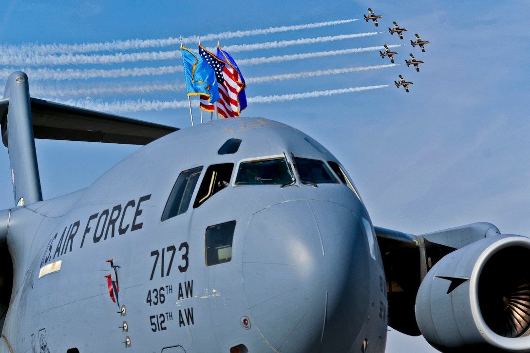 An aerobatic team flies over a U.S. Air Force C-17 Globemaster during the Dubai Air Show 2011 Airport Expo in Dubai, United Arab Emirates, Nov. 13, 2011. This year the static displays from the United States will be the B-1B Lancer, C-17 Globemaster, C-130 Hercules, E2-C Hawkeye, F-15C Eagle, F-16 Fighting Falcon, F-18 Hornet, MH-60R Seahawk, and V-22 Osprey. The event demonstrates a shared commitment both to regional security and to developing our key relationships throughout Southwest Asia. 
