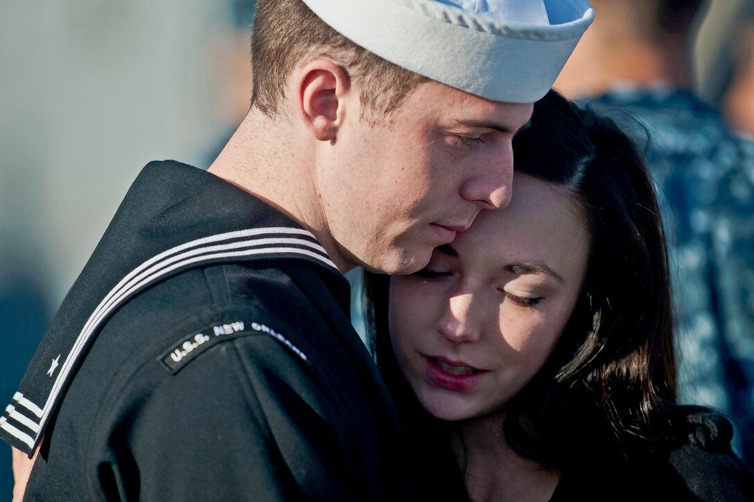 Navy Petty Officer 2nd Class Patrick Green embraces his wife before he embarks on the USS New Orleans for a scheduled deployment in San Diego, Nov. 14, 2011.  
