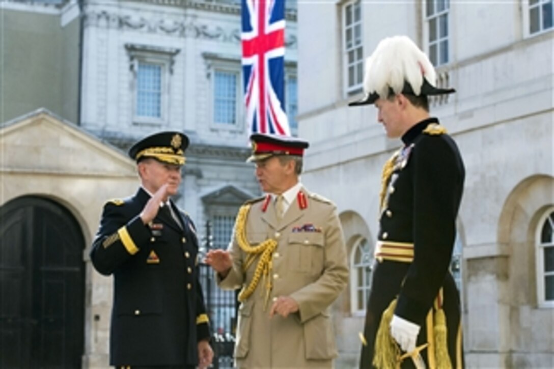 U.S. Army Gen. Martin E. Dempsey, left, chairman of the Joint Chiefs of Staff, talks with British Gen. Sir Nicholas Houghton, chief of Britain's defense staff, before an honor guard ceremony kicking off meetings between the two counterparts in London, June 10, 2014.