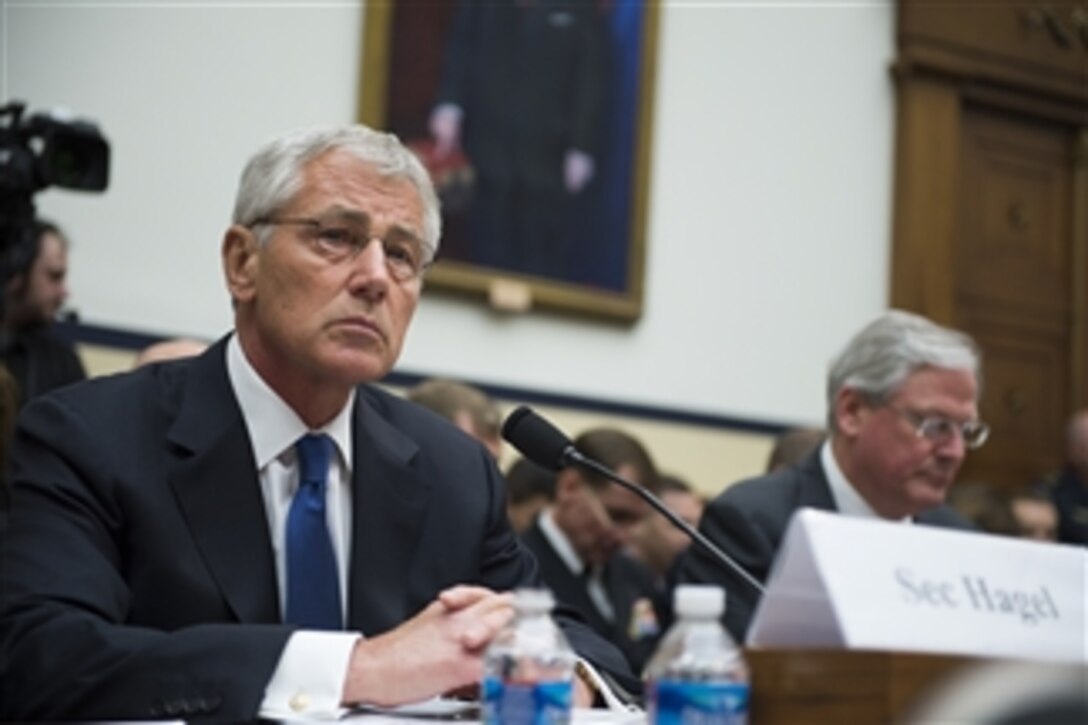 Defense Secretary Chuck Hagel, left, and Stephen Preston, the Defense Department’s general counsel, listen to opening statements on the transfer of Taliban detainees, May 31, 2014, during a hearing before the House Armed Services Committee in Washington, D.C., June 11, 2014.