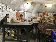 Brigadier General Gregg Olson, Command Element, Marine Forces Central Command Forward, Brig. Gen. Ali Al-Domi, commanding general, 99th Armoured Brigade, and members of the Exercise Eager Lion 2014, Coalition Forces Land Component Staff listen during a morning update brief. Eager Lion is a recurring, multinational exercise designed to strengthen military-to-military relationships, increase interoperability between partner nations and enhance regional security and stability. (U.S. Marine Corps photo by Master Sgt. William Price/Released)


