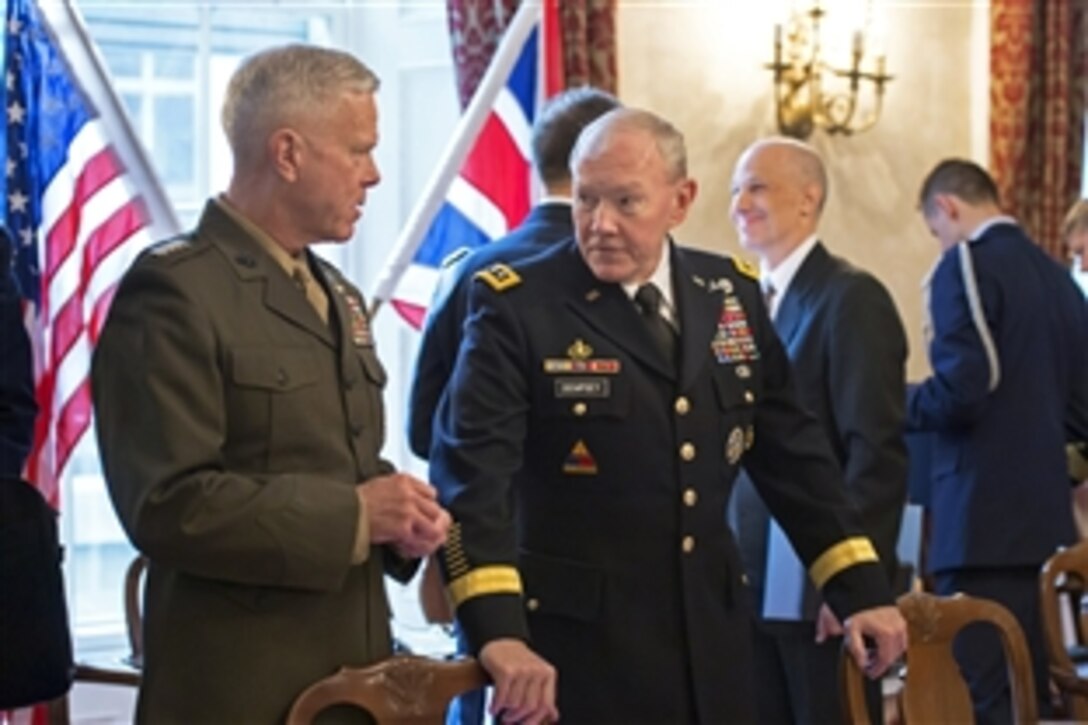 U.S. Army Gen. Martin E. Dempsey, right, chairman of the Joint Chiefs of Staff, talks with U.S. Marine Corps Commandant Gen. James F. Amos during a Defense Chiefs Strategic Dialog with the U.S. Joint Chiefs of Staff and their British counterparts in London, June 10, 2014.