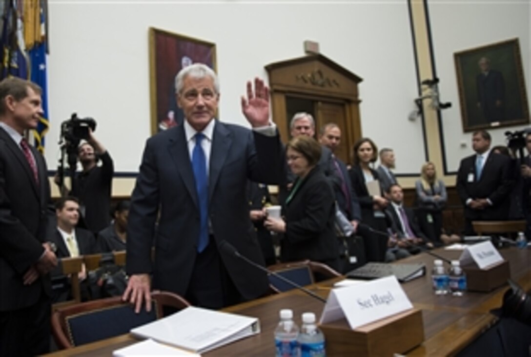 Defense Secretary Chuck Hagel greets members of the House Armed Services Committee before a hearing in Washington, D.C., June 11, 2014. Hagel testified on the transfer of Taliban detainees, May 31, 2014.