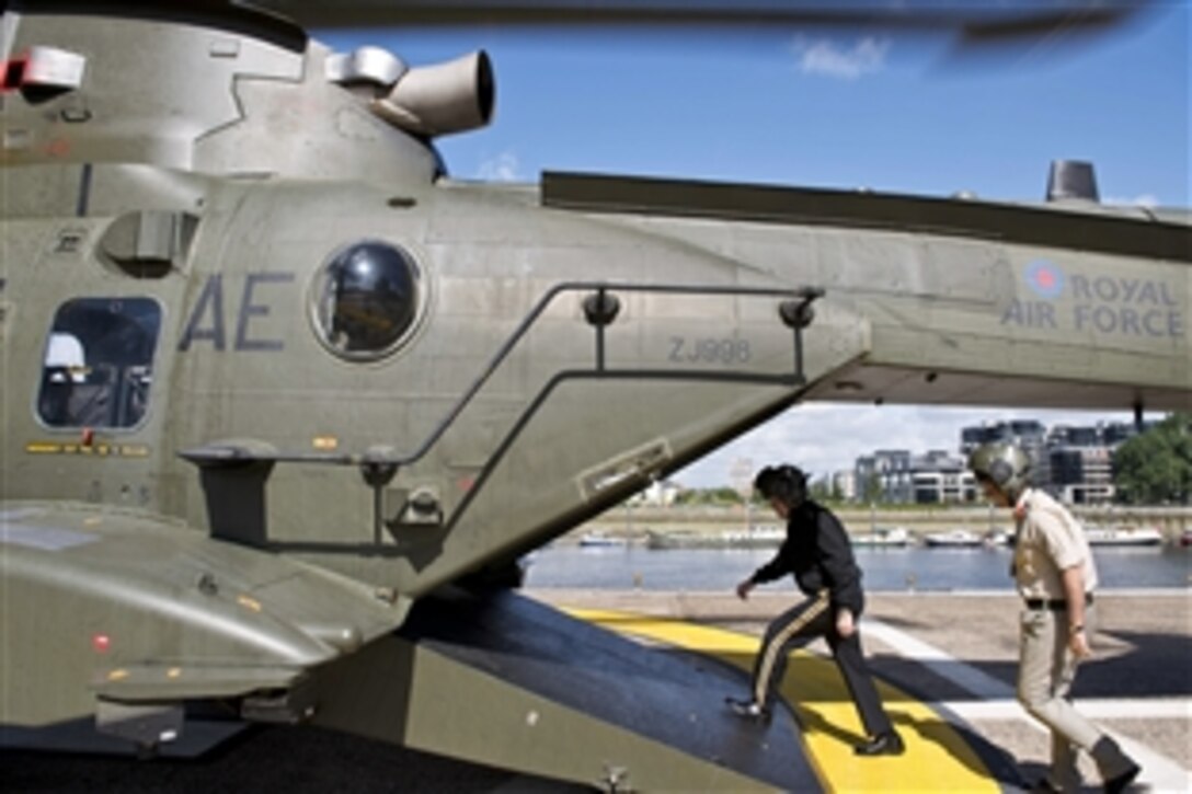 U.S. Army Gen. Martin E. Dempsey, chairman of the Joint Chiefs of Staff, and British Gen. Nickolas Houghton, chief of Britain's defense staff, walk onto an aircraft en route to speak to students at the Defense Academy of the United Kingdom in Shrivenham, England, June 11, 2014. 