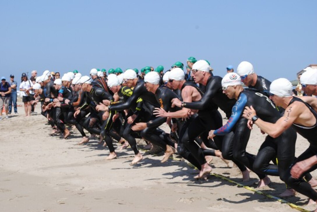 Male triathletes from the U.S. Navy, Army, Air Force and Marine Corps take off on the first leg of the 2014 Armed Forces Triathlon Championship — a one-mile ocean swim — Saturday, May 31, at Naval Base Ventura County (NBVC) Point Mugu.