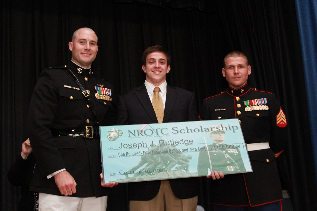 Joseph Rutledge, a resident of Middletown, R.I., and recent graduate of Middletown High School, is one of this year’s Naval Reserve Officer Training Corps Scholarship Program, Marine Corps Option, recipients. Capt. Thomas Abbott, the Executive Officer of Marine Corps Recruiting Station Springfield, Mass., presented Rutledge with a $150,000 scholarship during a high school awards ceremony June 11, 2014, at the school. (Official U.S. Marine Corps photo by Sgt. Richard Blumenstein.)