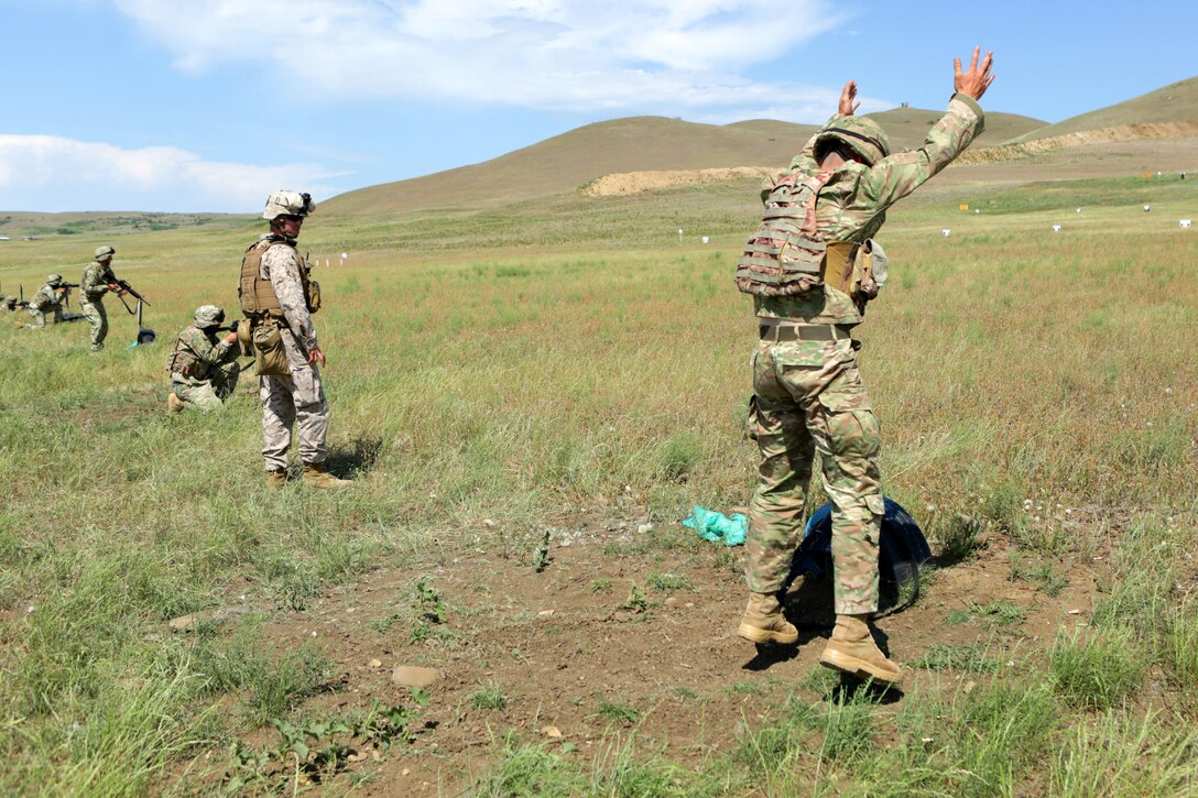 During a “stress fire,” where combat marksmanship is tested under metabolic stress induced by a high-intensity run and burpees, Cpl. Ryan M. Creamer, team leader, Black Sea Rotational Force 14, from 3rd Battalion, 8th Marines, checks a Georgian Armed Forces soldier’s form while he does five burpees before his first round of firing. Agile Spirit 14 is an annually-scheduled multilateral engagement hosted by the Caucasus country of Georgia that began to deepen the strategic partnership between the two countries by conducting brigade and battalion-level training engagements, to include small-unit interaction between the Marines and Georgians that demonstrates their commitments toward collective, global security.