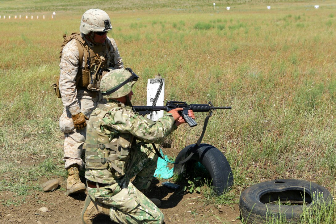 Assisting a Georgian Armed Forces soldier during a “stress fire,” that tests combat marksmanship after a high-intensity metabolic workout, Cpl. Daniel J. Castro, squad leader, Black Sea Rotational Force 14, assess the cause of the weapons malfunction during the fourth iteration of exercise Agile Spirit.  Agile Spirit 14 is an annually-scheduled multilateral engagement hosted by the Caucasus country of Georgia that began in 2011 to deepen the strategic partnership between the two countries by conducting brigade and battalion-level training engagements, to include small-unit interaction between the Marines and Georgians that demonstrates their commitments toward collective, global security