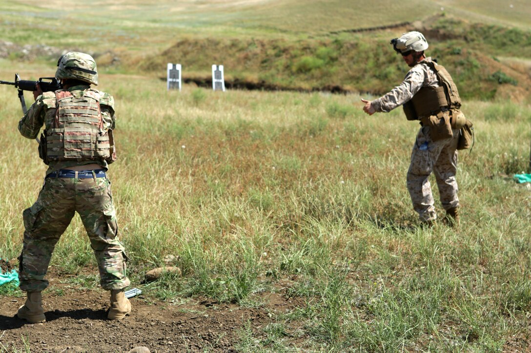 On the last round of a “stress shoot,” a test of combat marksmanship that includes a high-intensity circuit of running, burpees and engaging the targets, Cpl. Ryan M. Creamer, team leader from Black Sea Rotational Force 14, helps a Georgian Armed Forces soldier get into the proper combat stance during the fourth iteration of exercise Agile Spirit. Agile Spirit 14 is an annually-scheduled multilateral engagement hosted by the Caucasus country that began in 2011 to deepen the strategic partnership between the two countries by conducting brigade and battalion-level training engagements, to include small-unit interaction between the Marines and Georgians that demonstrates their commitments toward collective, global security.
