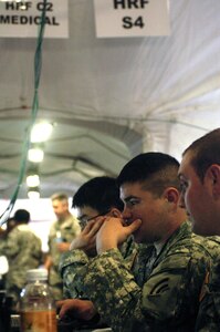 Army Spc. Louis Cesario, focuses while training as a liaison officer for the Homeland Response Force Tactical Operations Center in Utica, N.Y. May 16, 2012. Cesario helps the TOC provide important information to the civilian first responders in the event of an emergency situation.