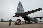 A loadmaster from the Kentucky Air National Guard’s 123rd Airlift Wing directs an all-terrain vehicle May 14, 2012, as its driver exits the cargo bay of a Kentucky Air Guard C-130 onto the flight line at Fort Campbell, Ky. The 123rd was participating in an exercise to test its response to a simulated earthquake in the New Madrid Seismic Zone, a fault line that originates near New Madrid, Mo., and stretches southwest across four states.  About 20 Kentucky Airmen, all assigned to the 123rd’s Initial Response Hub package, assessed Campbell Army Airfield for earthquake damage, determined the kinds of airlift operations the facility could support and opened the ramp for incoming relief and aeromedical evacuation flights within five hours of being called to duty. (U.S. Air Force photo by Maj. Dale Greer)