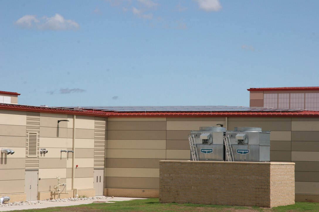 A look at the Mission Training Complex where the photovoltaic panels are in place on the roof. They are just visible on the roof above the two HVAC units.