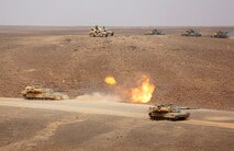 U.S. M1 Abrams tanks with Battalion Landing Team 1/6, 22 Marine Expeditionary  Unit,  fire at targets during the Combined Armed Live Fire Exercise (CALFEX) demonstration in support of Exercise Eager Lion 2014, June 5, at Jebel Petra, Jordan.  Eager Lion is a recurring, multinational exercise designed to strengthen military-to-military relationships, increase interoperability between partner nations and enhance regional security and stability.   (U.S. Marine Corps photo Master Sgt. Will Price, MARCENT/Released)