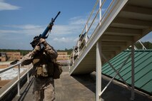 Marines with Alpha Company, 8th Engineer Support Battalion, 2nd Marine Logistics Group move to clear the rooftop of a building during a Military Operations in Urban Terrain exercise aboard Camp Lejeune, N.C., June 5, 2014. The Marines trained with infantry tactics in an urban environment to maintain the combat readiness required as combat engineers. 