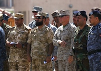 Lieutenant Gen. Robert B. Neller, commander, U.S. Marine Corps Forces Central Command, along with other general officers from five different continents, watch during a tour of the USNS 1st LT Baldomero Lopez, as a 60-ton M1 Abrams tank is lifted aboard the Maritime Pre-Positioning vessel, May 28, at the Port of Aqaba, in the Kingdom of Jordan, in support of Exercise Eager Lion 2014.  Eager Lion is a recurring, multinational exercise designed to strengthen military-to-military relationships, increase interoperability between partner nations and enhance regional security and stability.  (U.S. Marine Corps photo by Master Sgt. Will Price/Released)