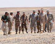 PETRA, Jordan (June 1, 2014) -- Brigadier Gen. Gregg Olson and Jordanian Armed Forces Brig. Gen.  Ali Al-Domi, Commanding General, 99th Armoured Brigade,  greet U.S. Army Maj. Gen. Robert Catalanotti, U.S. Central Command director of Exercises and Training Directorate, as he arrives to review a range in support of Eager Lion 2014 at a base near Petra, Jordan,  June 1 Eager Lion is a recurring, multinational exercise designed to strengthen military-to-military relationships, increase interoperability between partner nations and enhance regional security and stability.   (U.S. Marine Corps photo by; Sgt James A. Hall, CE MARFOR CENTCOM (FWD) Combat Camera/Released)