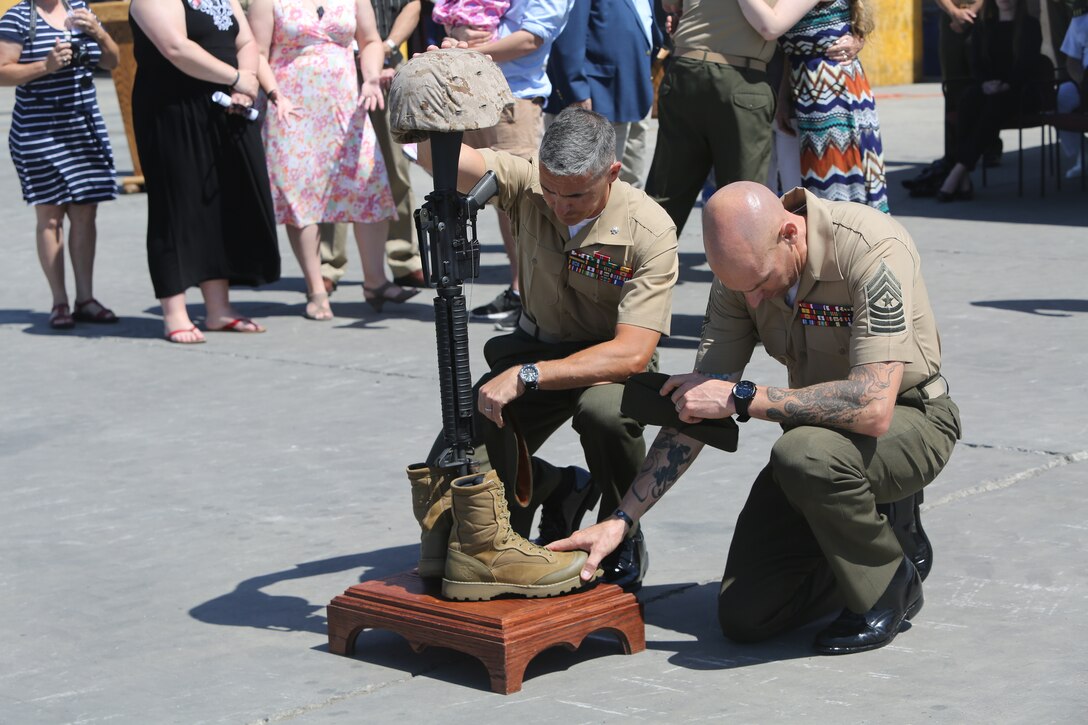 Lt. Col. Andrew Winthrop, the commanding officer of 1st Combat Engineer Battalion, 1st Marine Division, I Marine Expeditionary Force, and Sgt. Maj. Daniel Krause, the 1st CEB sergeant major, kneel in front of a battle cross in memory of Lance Cpl. Matthew Rodriguez after a memorial service aboard Camp Pendleton, Calif., June 11, 2014.